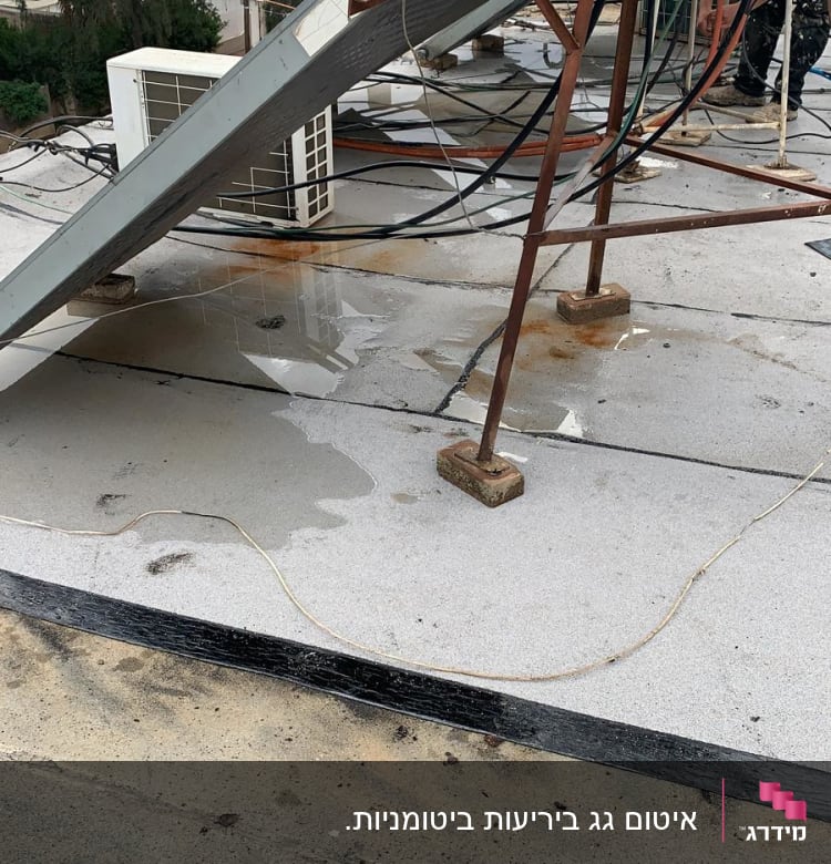 גג עם שלוליות מים, חוטים ומתקן מתכת